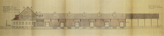 Ein detailliertes Gebäudeentwurf mit vielen Fenstern auf einem Blatt Papier mit begleitendem Text, das einen Bauplan für eine neue Schule darstellt.